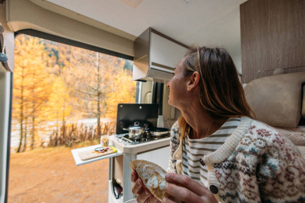 istock Woman Enjoying a Meal in Cozy Camper Van Kitchen 2184177547