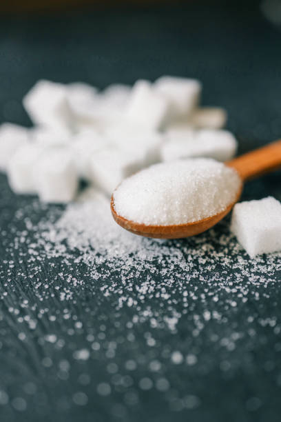 istock White crystalline sugar cubes on a wooden spoon 2184177860