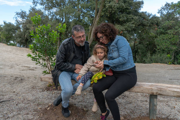 istock Family Bonding Moment on a Park Bench 2184179614