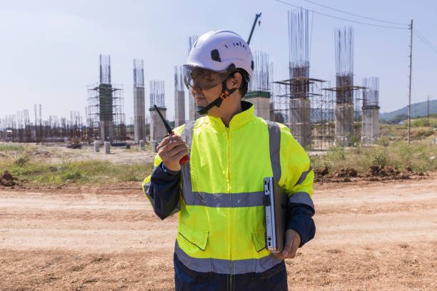 istock Asian engineer working at site of a large building project. Engineering, construction site and team outdoor for Transportation construction project. 2184179703