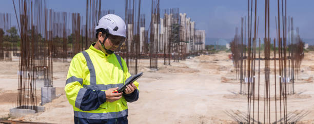 istock Asian engineer working at site of a large building project. Engineering, construction site and team outdoor for Transportation construction project. 2184179805