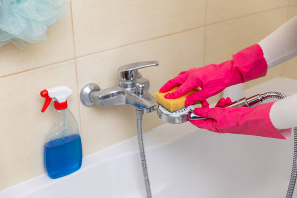 istock Do it yourself by cleaning the bathroom faucet using a sponge and protective gloves 2184180767