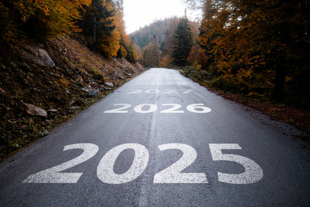 istock New year 2025. Text 2025 Written on the Asphalt Road with Autmun Trees 2184180890