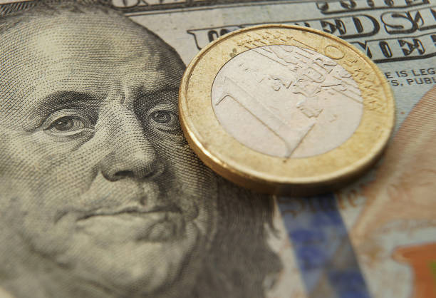 istock Macro hundred dollar bill and Euro coin 2184181974