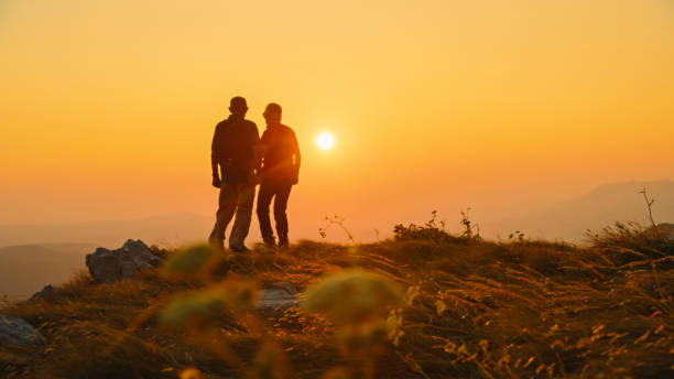 istock Senior Couple Enjoys Sunset While Hiking 2184183370
