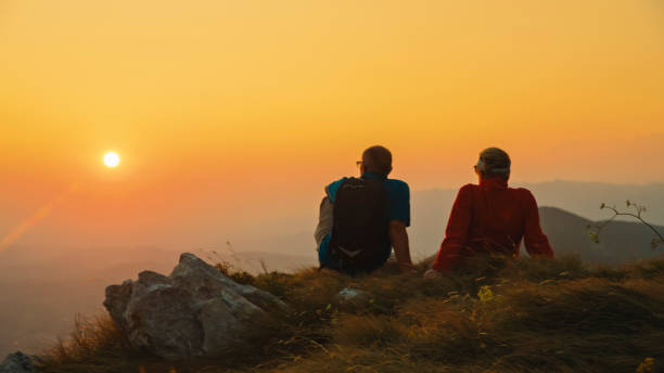 istock Elderly Couple Enjoys Sunset on Mountain Hike 2184183381