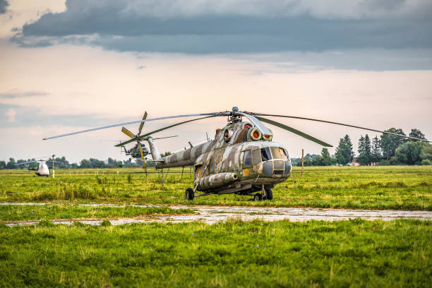 istock Old military helicopter at airbase field 2184185933