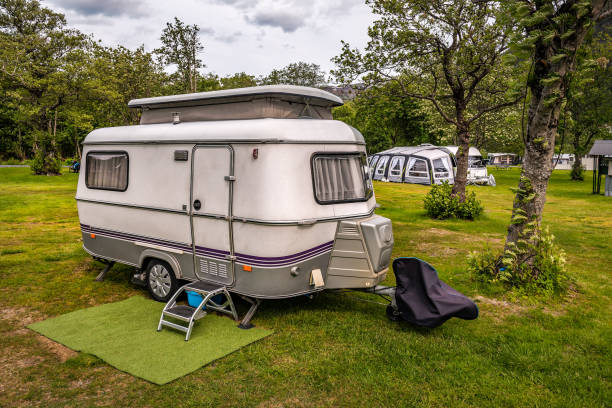 istock White camping trailer stands in campsite 2184186046