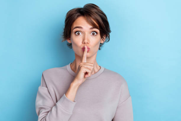 istock Photo of pretty impressed lady stylish outfit pullover finger touch lips shh stop conversation  isolated on blue color background 2184186330