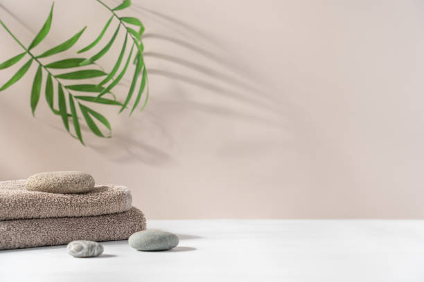 istock Stack of terry towels on light background with tropical plants 2184186504