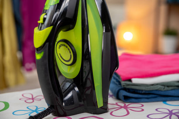 A vibrant steam iron sits on a colorful ironing board, making it ideal for achieving wrinklefree clothing