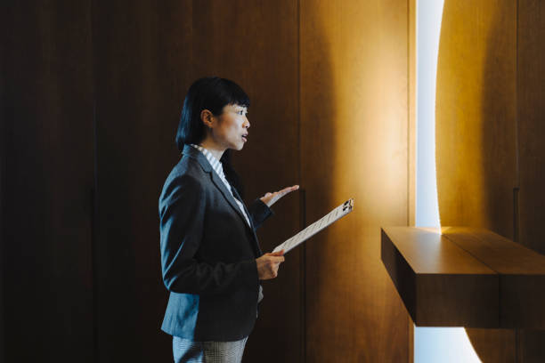 istock One woman rehearsing a speech in mirror at home 2184188613