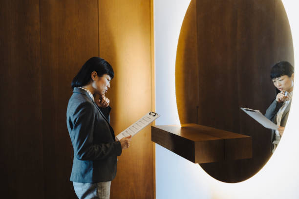 istock One woman rehearsing a speech in mirror at home 2184189642