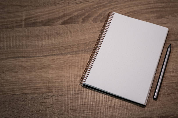 istock New Year Goals 2025: Organized Notebook on Wooden Desk Still Life 2184191312