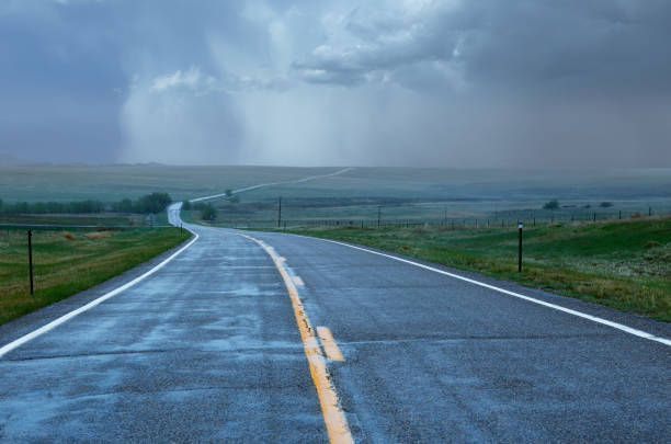 istock Rain Storm On Winding Road In American Midwest 2184191434