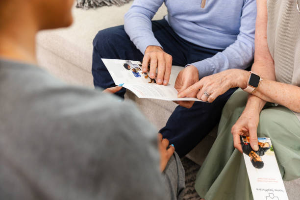 istock Senior woman asks unrecognizable nurse questions about brochure 2184191497