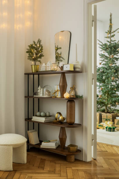 istock Creative composition of christmas living room interior with console, pouf, candle with candlestick, decorations, gifts and accessories. Home decor. Template. 2184192407