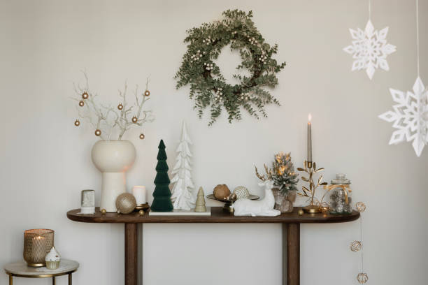istock Christmas-themed sideboard with decorative trees, candles, and festive greenery. A warm, welcoming holiday setup. 2184192652