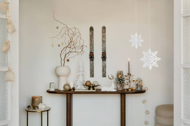 Christmas-themed sideboard with decorative trees, candles, and festive greenery. A warm, welcoming holiday setup.