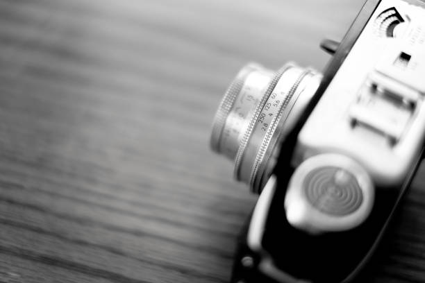 Detail of old worn vintage film camera closeup on wooden surface