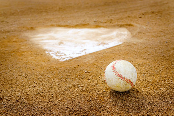 istock Old Leather Baseball on Field by Home Plate or Base 2184192911