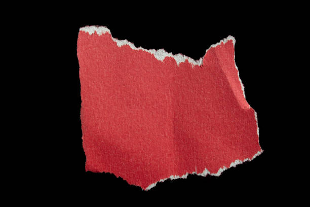 istock Ripped torn red paper piece isolated on black background 2184193053