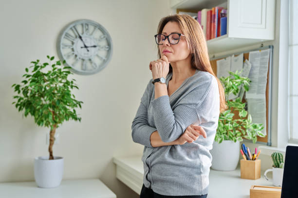 Middle aged unhappy thoughtful suffering lonely woman, at home