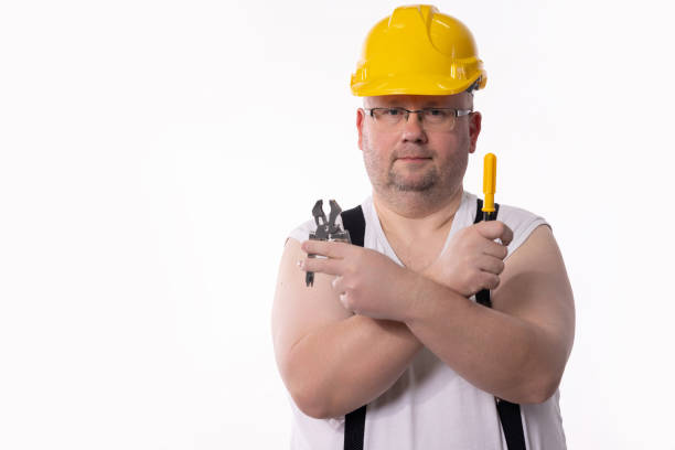 A hardworking construction worker proudly showcasing his tools and hard hat, fully prepared for the job ahead