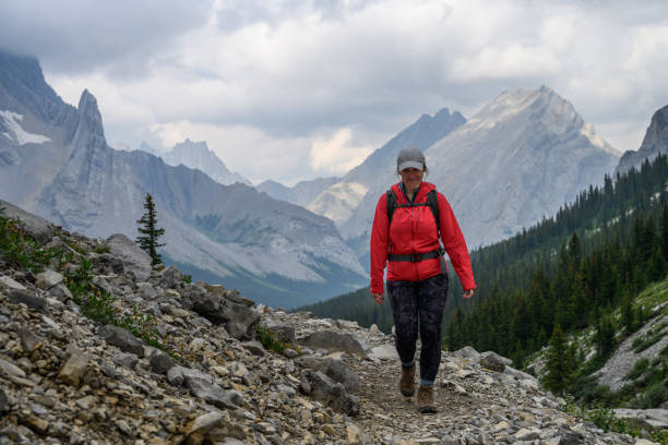istock Woman hikes along mountain trail 2184198614