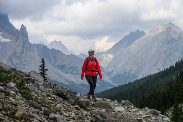 istock Woman hikes along mountain trail 2184198618