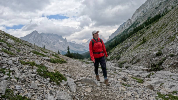 istock Woman hikes along mountain trail 2184198731