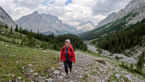 istock Woman hikes along mountain trail 2184198733