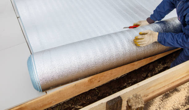 istock A person is cutting a roll of insulation 2184199049