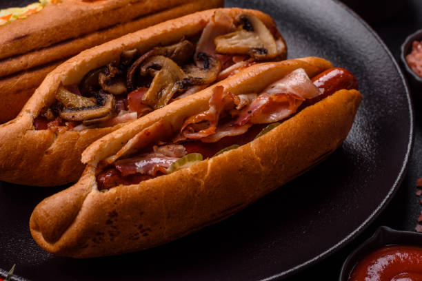 istock Hotdog with grilled sausage with bacon and mushrooms 2184200558