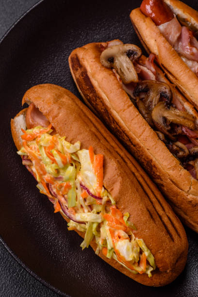 istock Hotdog with grilled sausage with cabbage, carrots and onions 2184200595