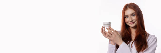 istock A Beautiful Skincare Model Gracefully Holding a Cream Jar in a WellDesigned Studio Setting 2184200699