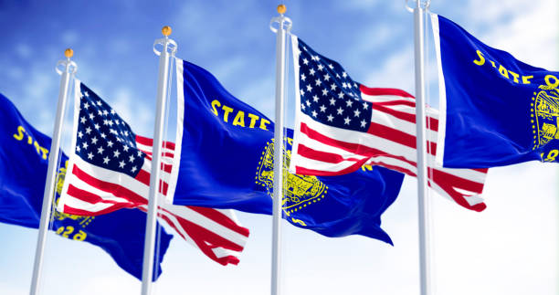 istock Oregon state flags waving in the wind with the american flags on a clear day 2184200961