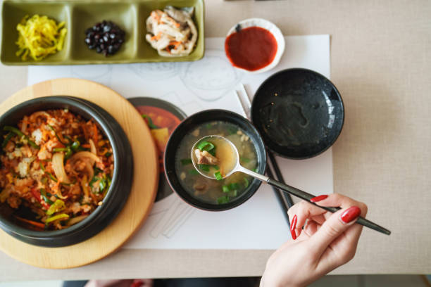 istock Dining table with a soup bowl and Korean Food Bibimbap from above. 2184202110