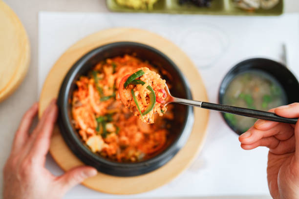 Young woman eating bibimbap at a Korean Restaurant.
