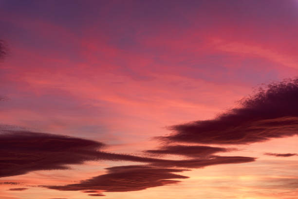 Vivid Sunset Sky with Colorful Clouds.A vivid sunset sky adorned with colorful clouds in shades of orange, yellow, and magenta, offering a breathtaking view of nature's palette