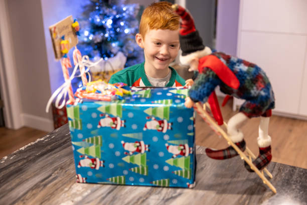Young Cute Redhead Boy Looking at a DIY Christmas Elf Trap