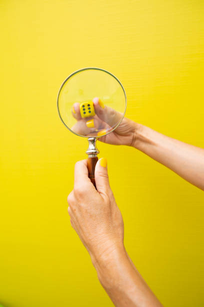 istock Dice looked at through a magnifying glass behind 2184208130