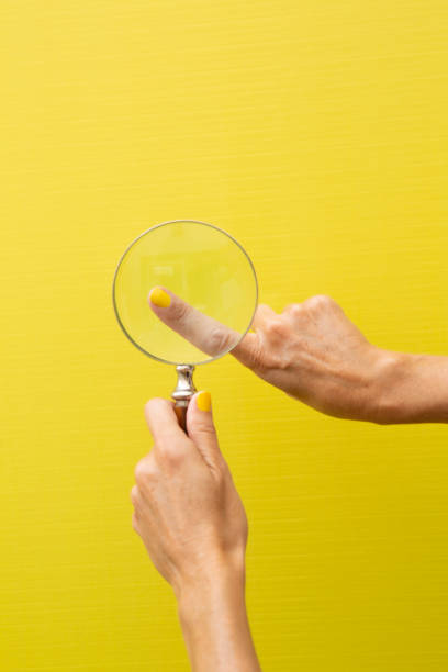 istock Finger of a hand viewed through a magnifying glass 2184208139