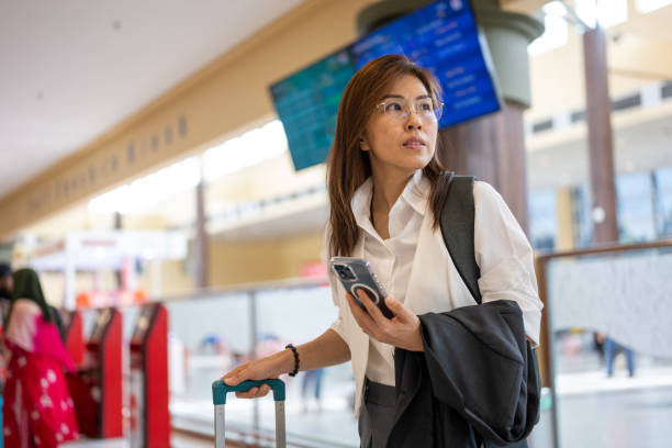 istock Ready for Takeoff: A Businesswoman’s Final Check at the Airport 2184208702