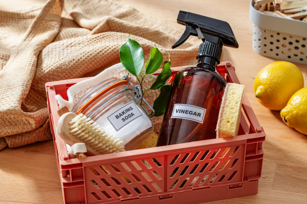 Home cleaning with natural and eco friendly products: Baking soda, white vinegar, lemon, scrubbing brush and cleaning sponge