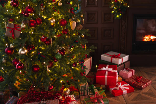 istock Classical Christmas decorated interior living room with fireplace. Christmas tree with red golden ornament decorations gift boxes. Modern classic style interior design apartment, Christmas eve at home 2184211359