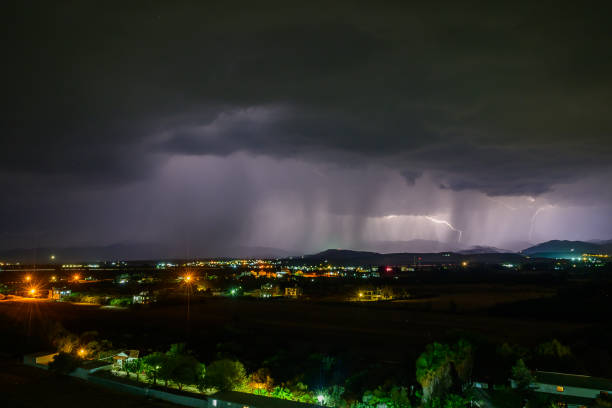Lightning discharges in the night sky during a thunderstorm. Large thundercloud and lightning discharges. Storm.