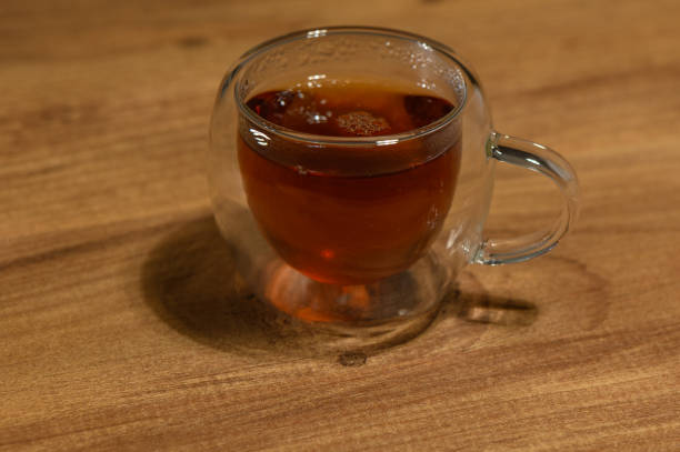 istock A steaming cup of herbal tea resting on a wooden table during a cozy evening 2184213290
