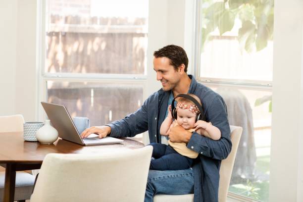istock Young businessman works from home while caring for daughter 2184214687