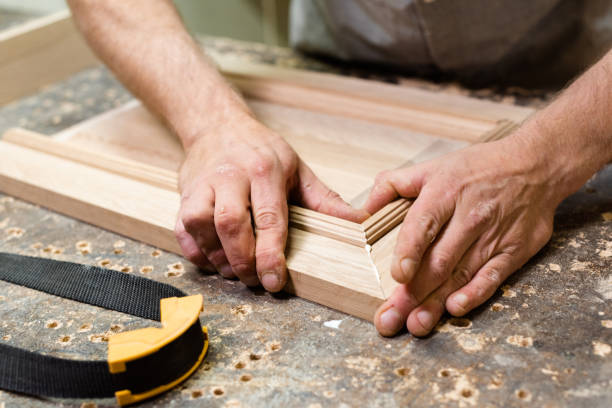 The carpenter combines the parts for gluing